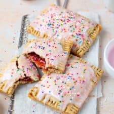 Homemade Vegan Strawberry Poptarts topped with pink vanilla icing and sprinkles