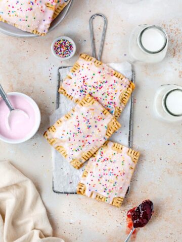 Homemade Vegan Strawberry Poptarts topped with pink vanilla icing and sprinkles