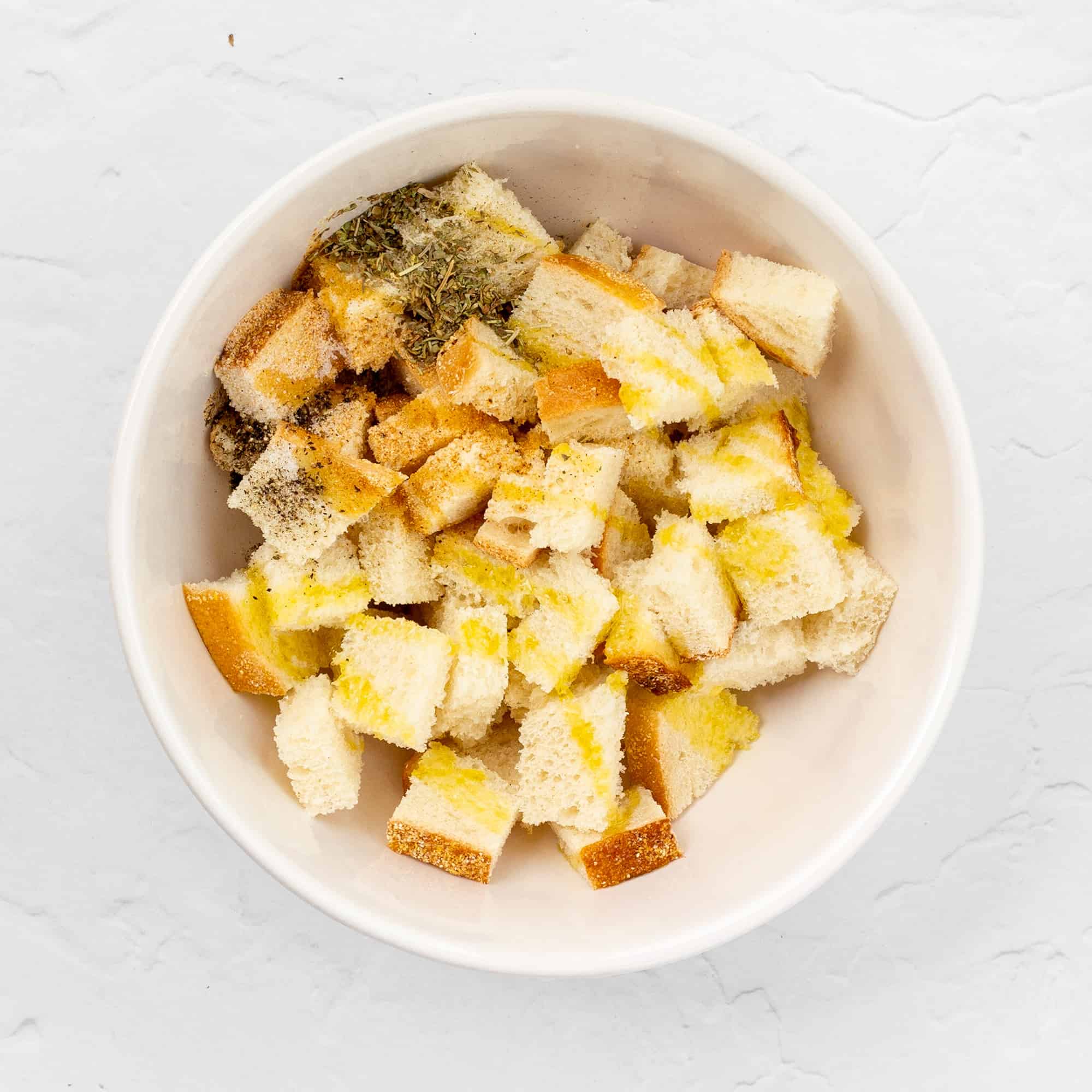 sourdough bread cubes in a bowl with seasonings