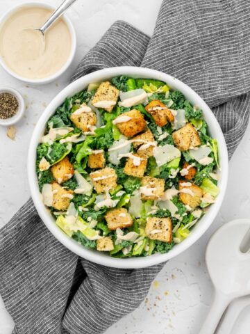 Vegan Kale & Romaine Caesar salad topped with croutons and parmesan