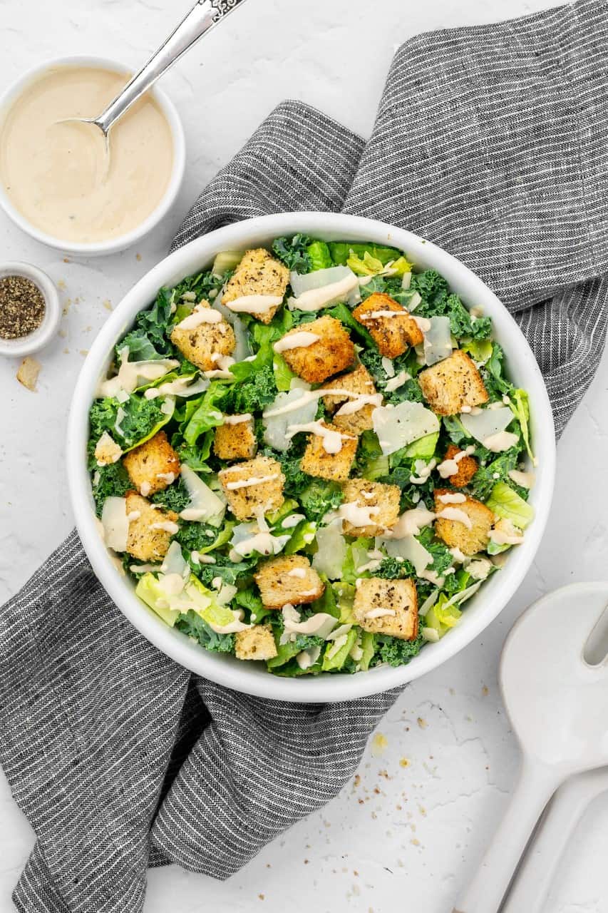 Vegan Kale & Romaine Caesar salad topped with croutons and parmesan
