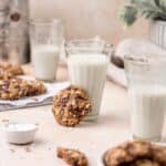 oatmeal chocolate chip cookie leaned on a glass of milk