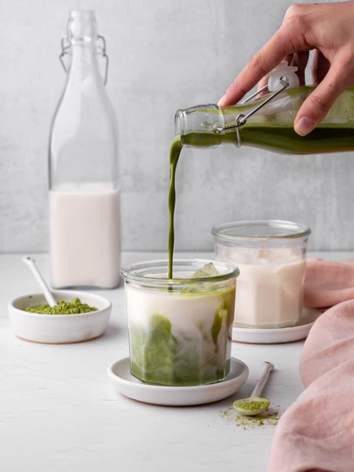 pour matcha paste into a glass filled with milk and ice