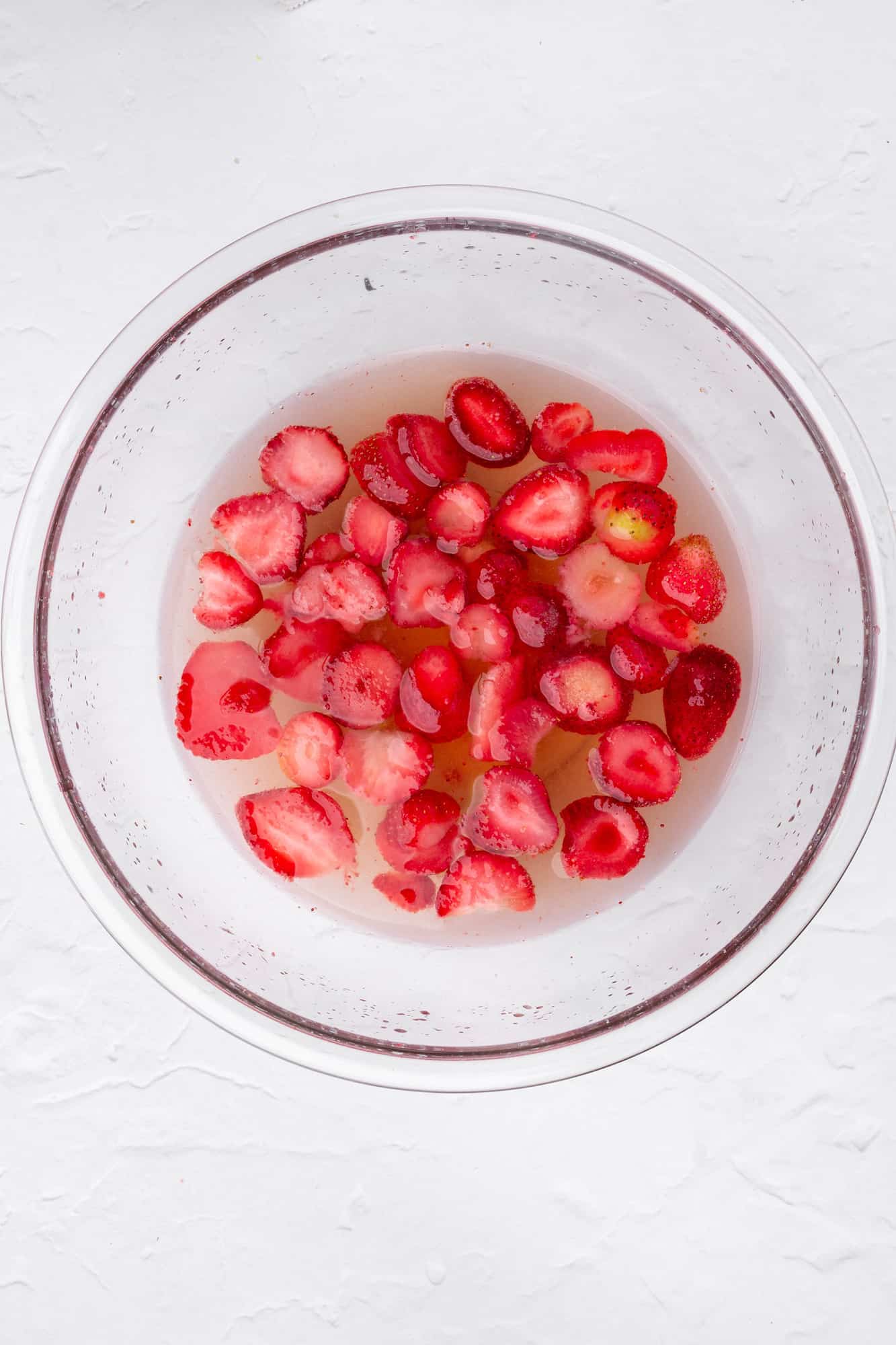 strawberries, water, lemon juice, and maple syrup in a bowl
