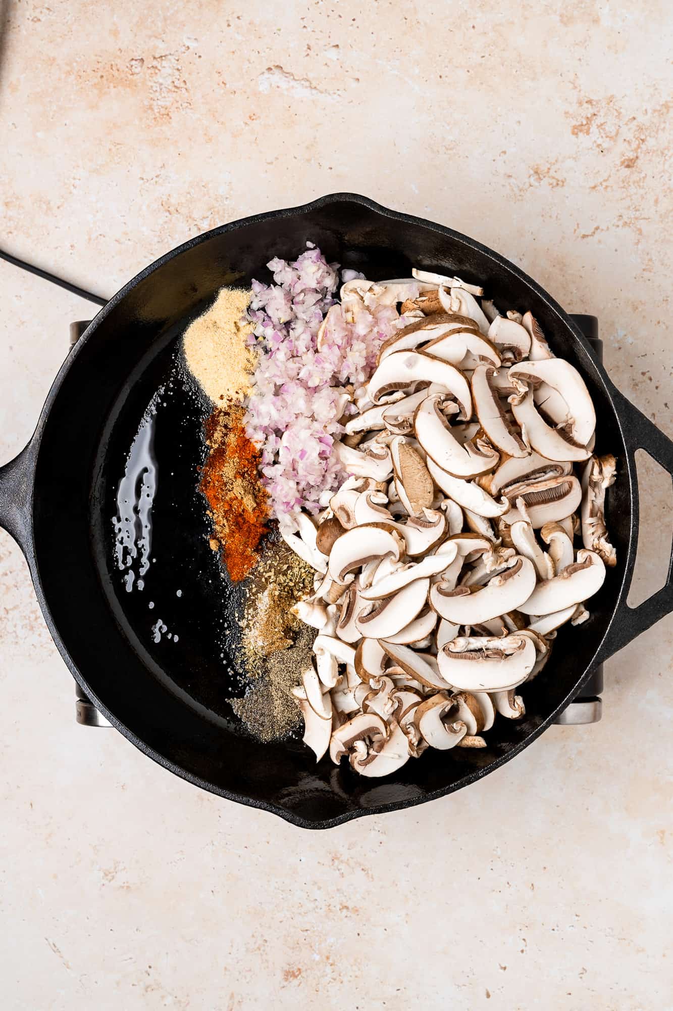 cast iron skillet with mushrooms, shallots, spices, soy sauce
