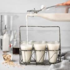 oat milk being poured into a glass