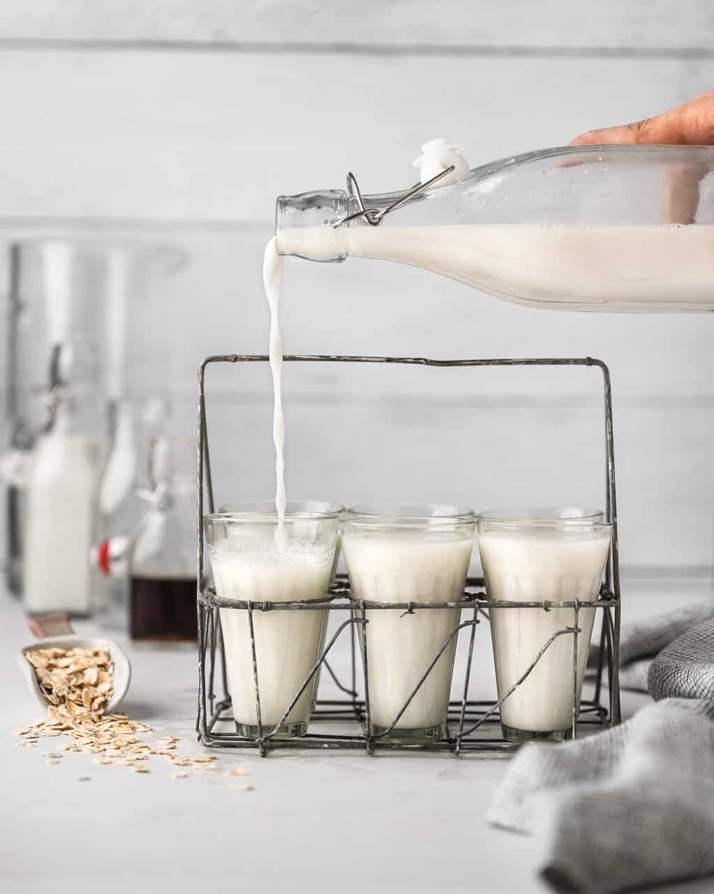 oat milk being poured into a glass