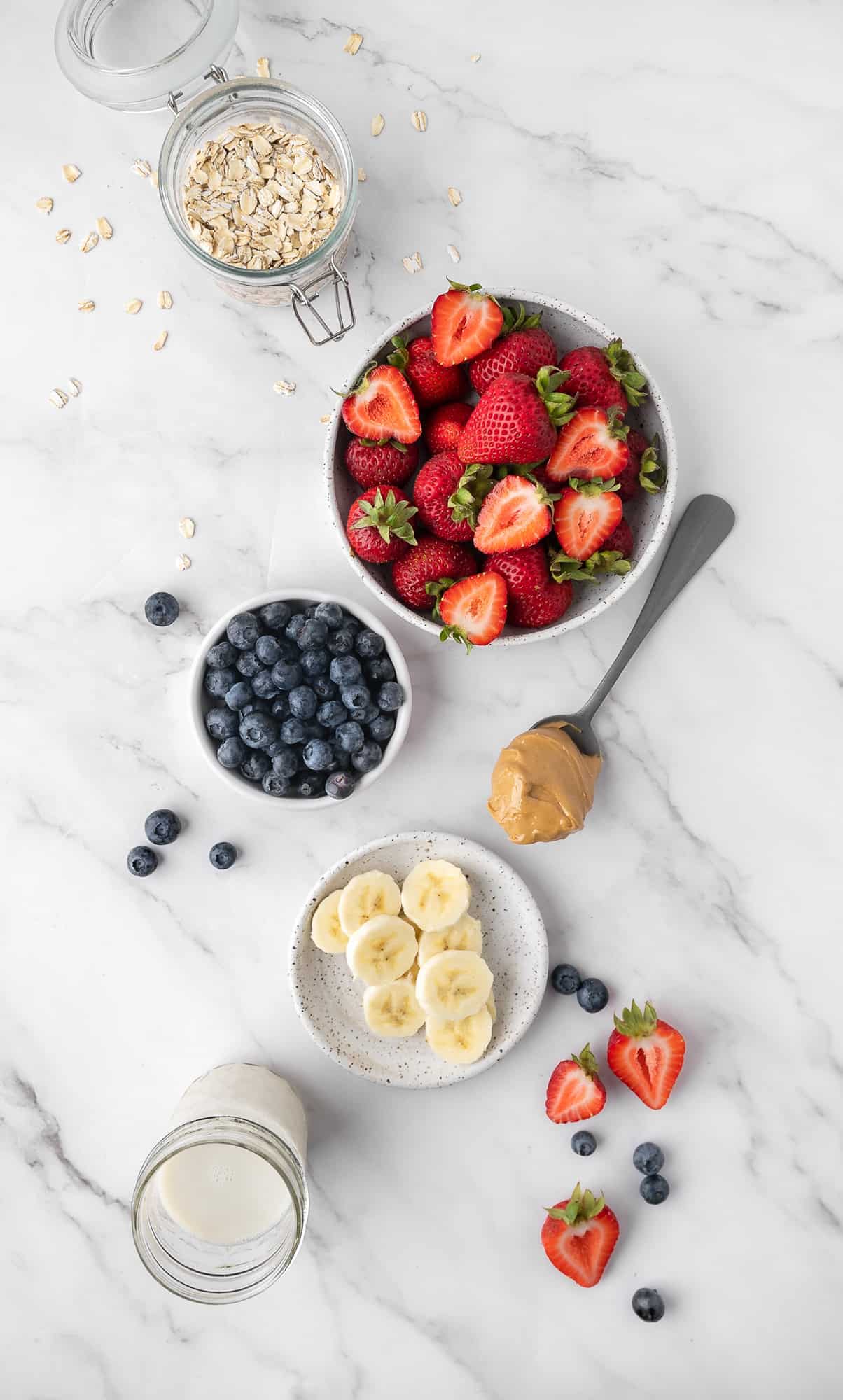 ingredients for peanut butter & jelly smoothie on a granite counter