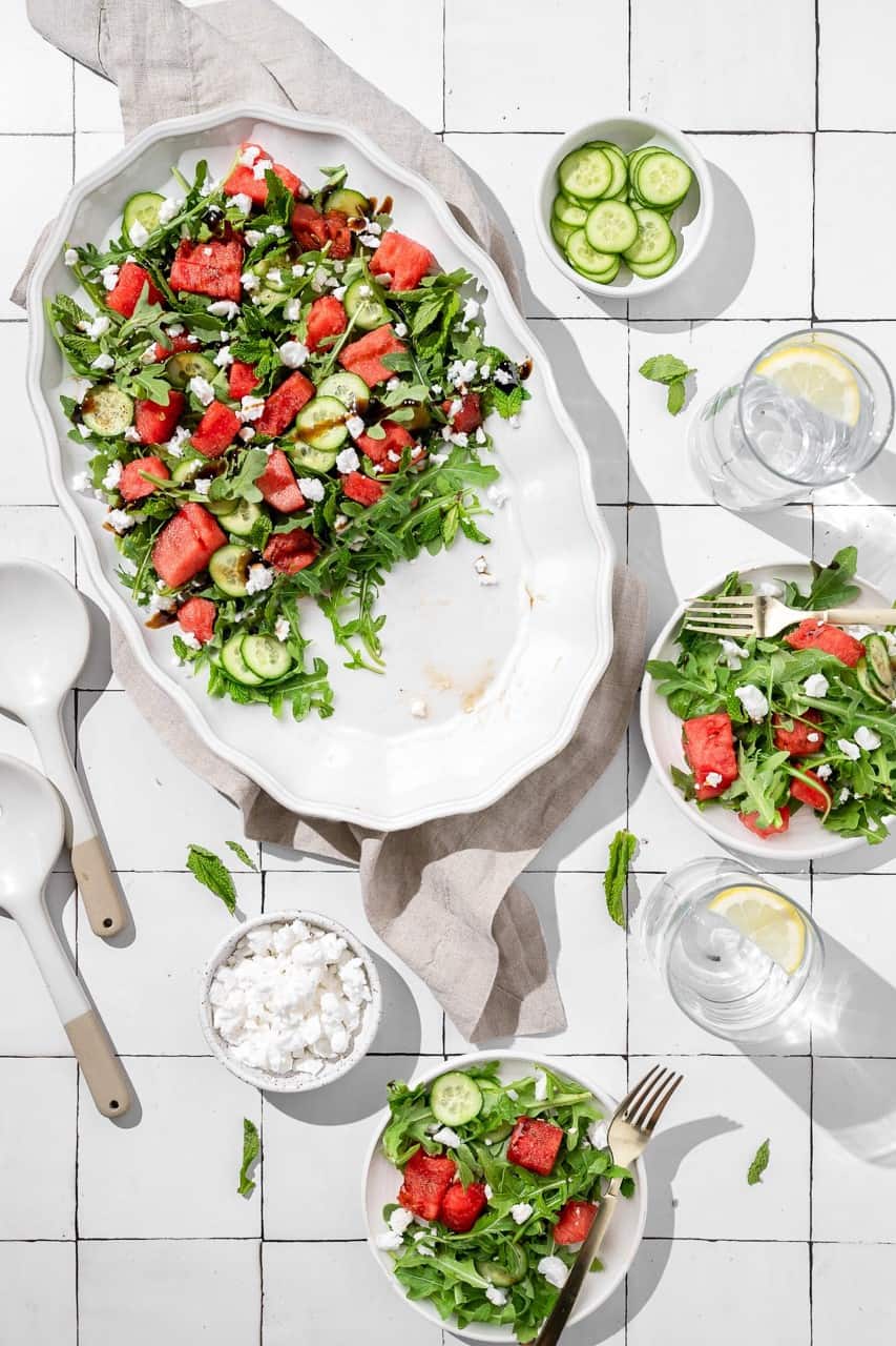 watermelon cucumber salad being served onto plates