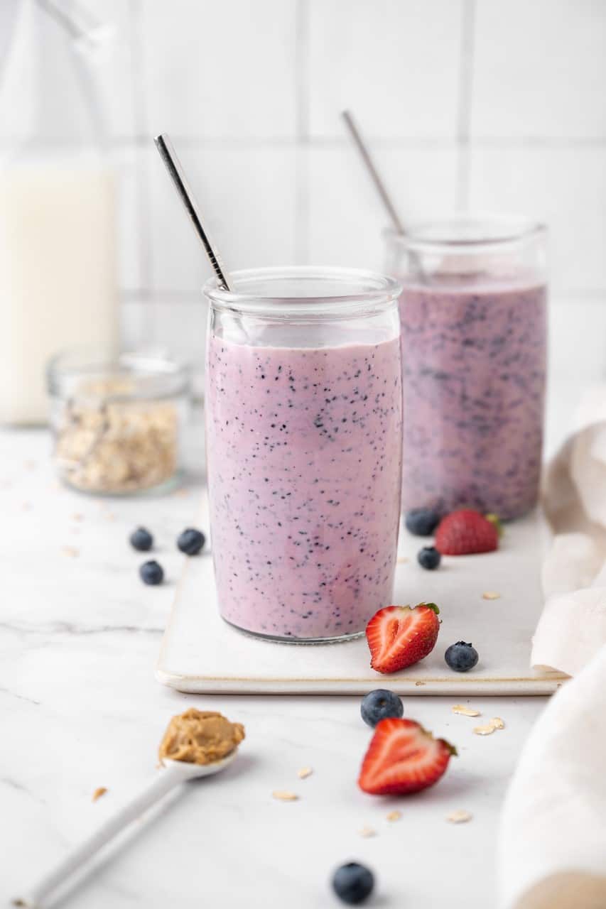 peanut butter & jelly smoothie in a glass on a cutting board