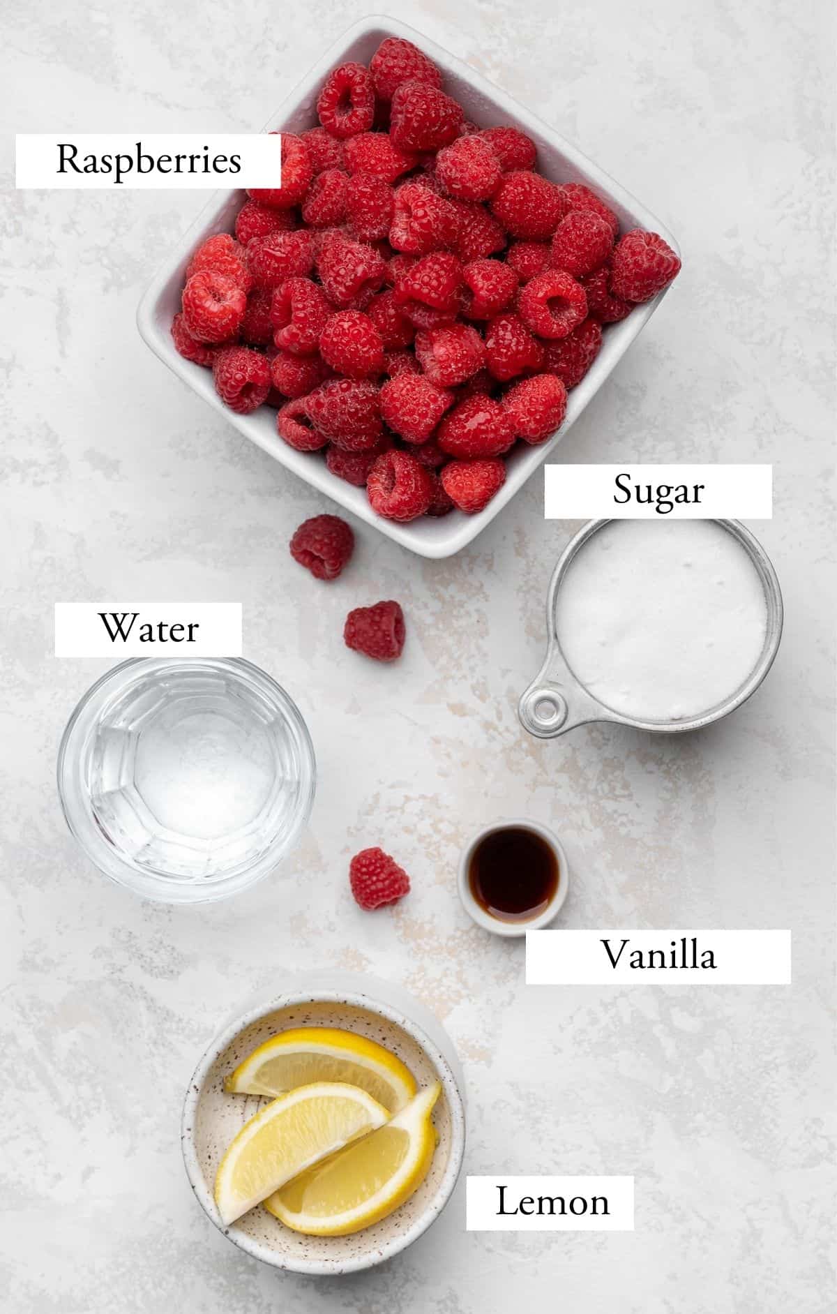 Ingredients for raspberry sorbet - raspberries, lemon, sugar, water, and vanilla