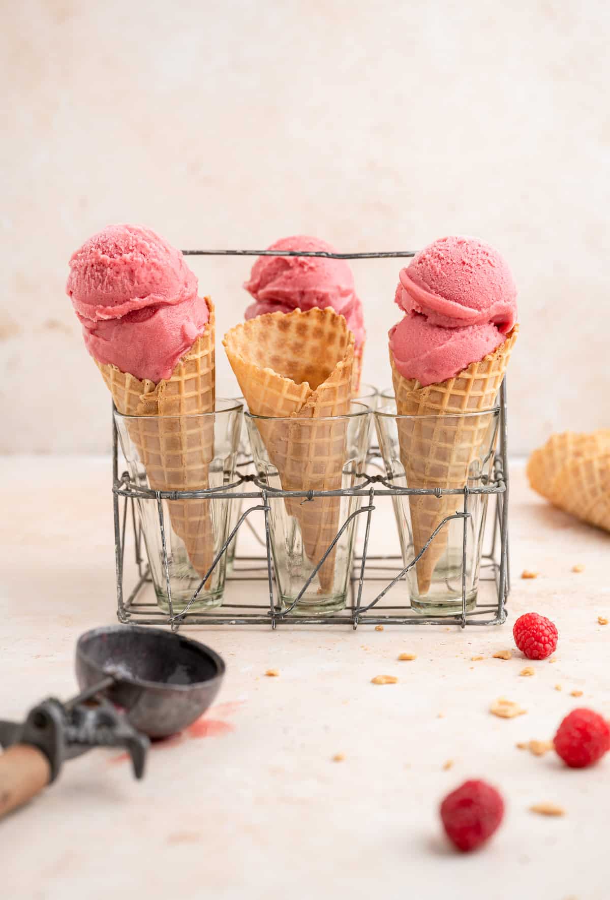 3 icecream cones topped with 2 scoops of raspberry sorbet each