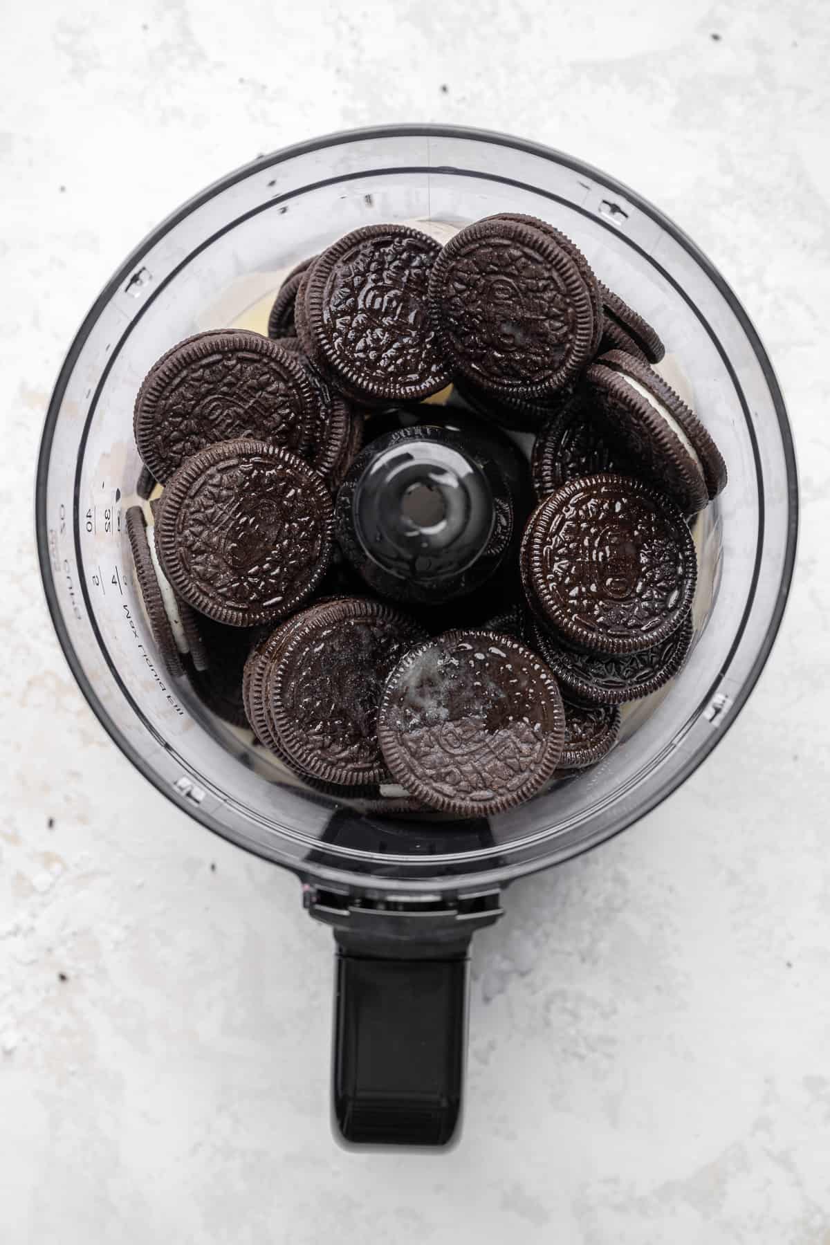 whole oreos and melted butter in a food processor