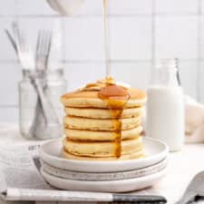 stack of vegan buttermilk pancakes topped with butter and maple syrup