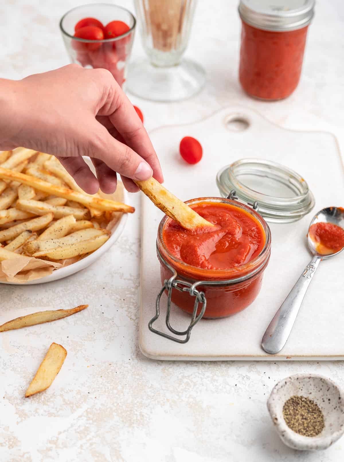 french fry being dipped into homemade ketchup