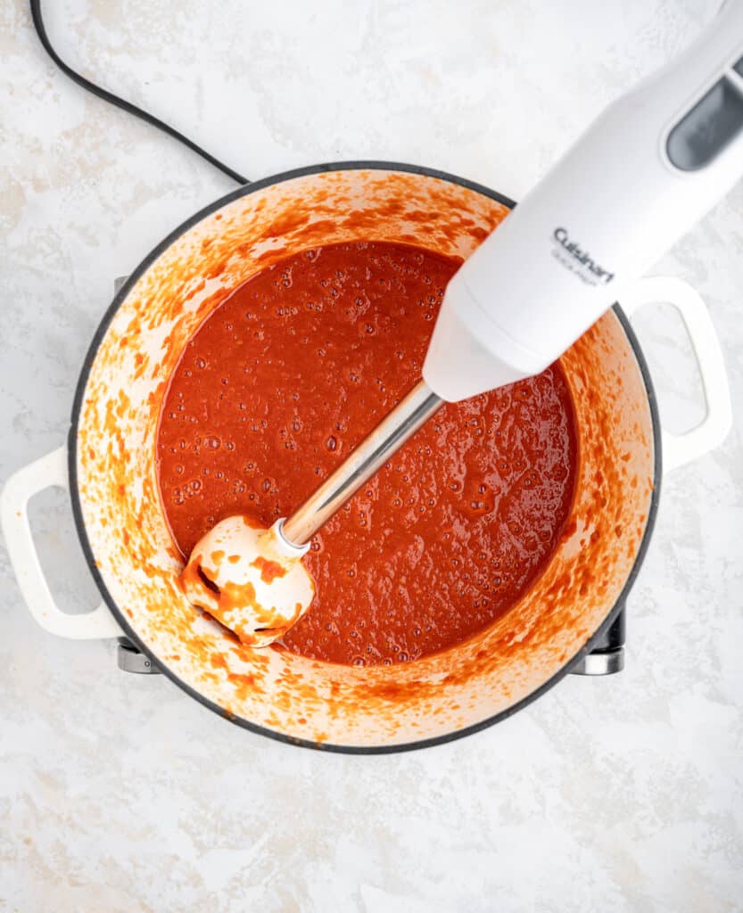 homemade ketchup being pureed with an immersion blender