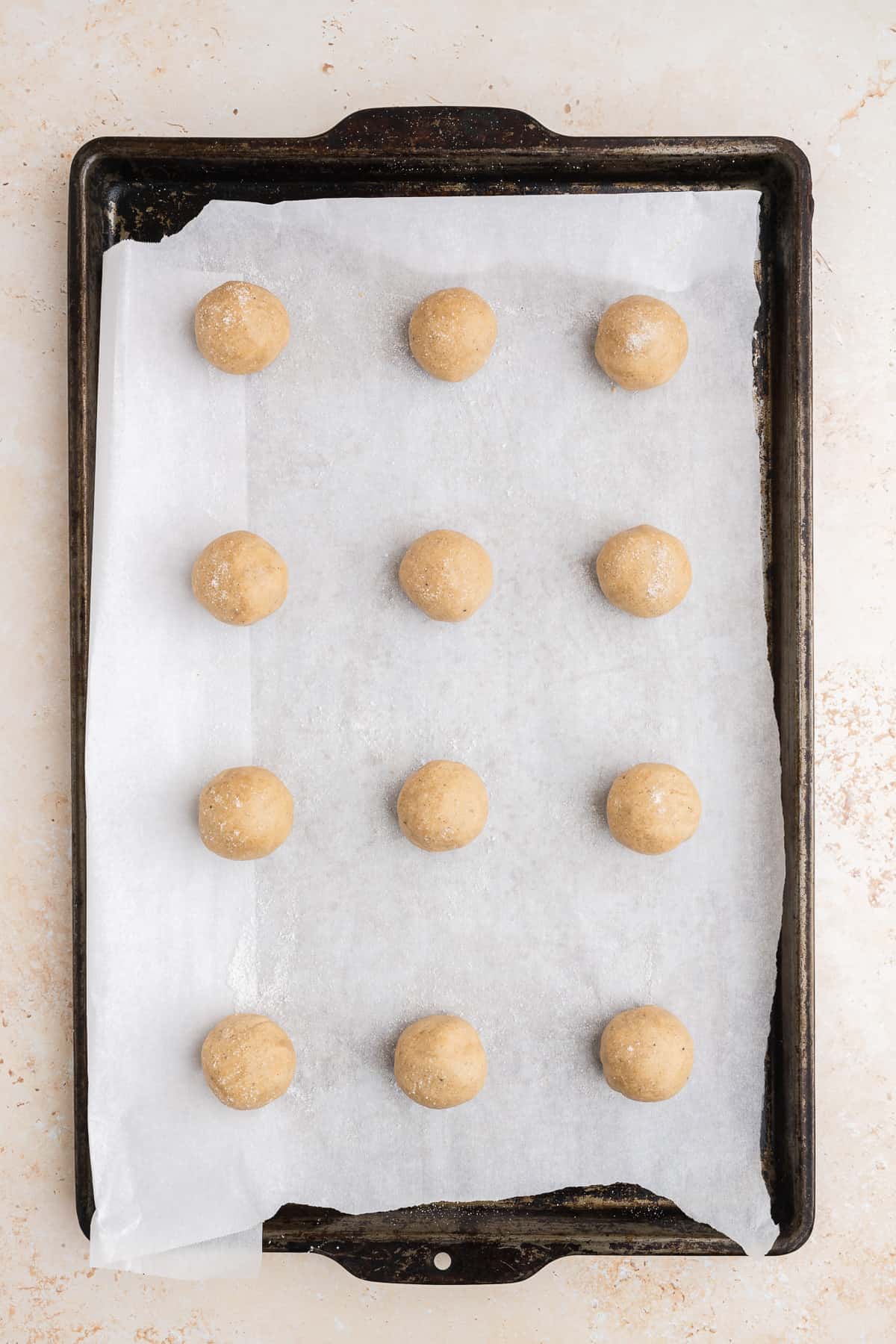 cookie dough balls on a baking sheet, unbaked