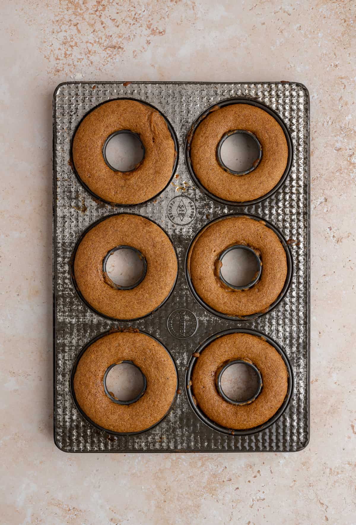baked apple cider donuts in an antique donut pan.