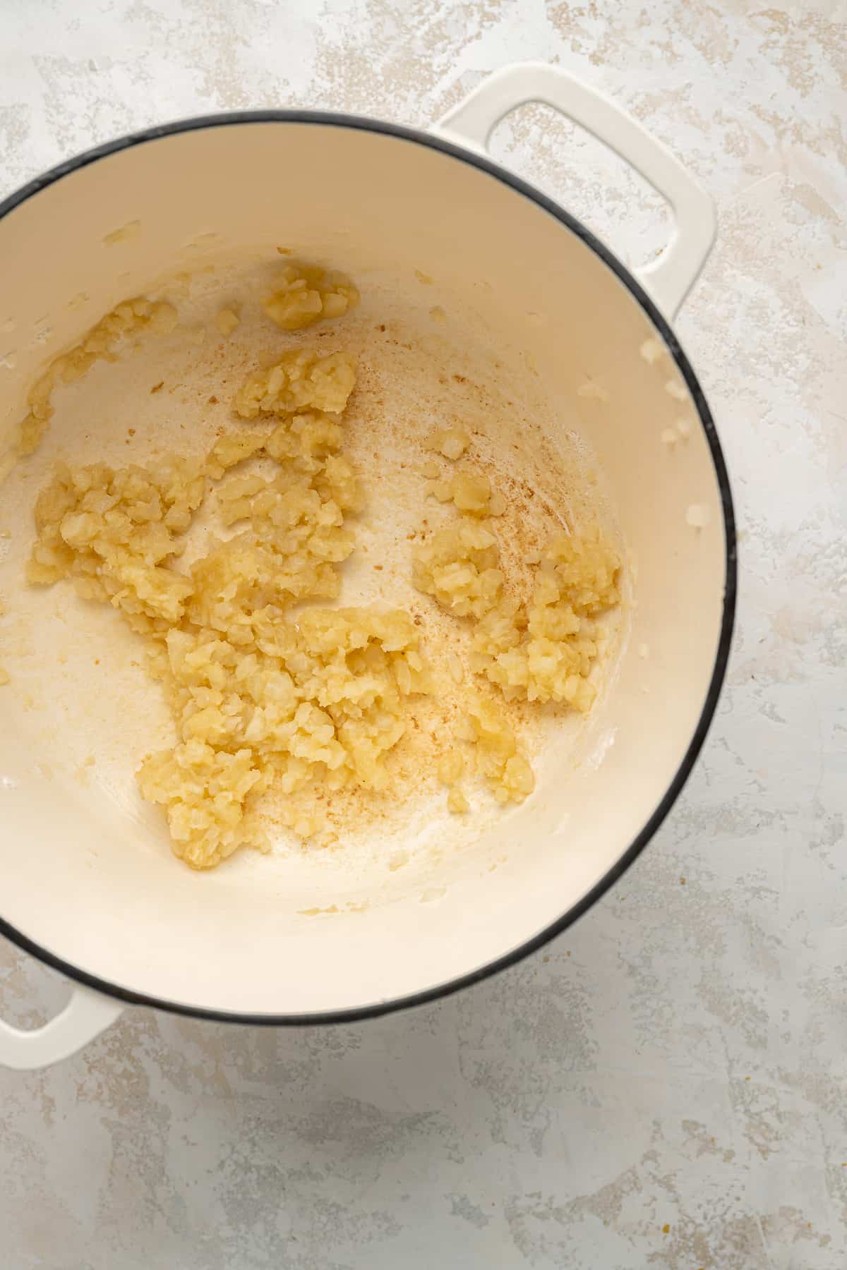 A roux (butter & flour) in a white dutch oven pot.
