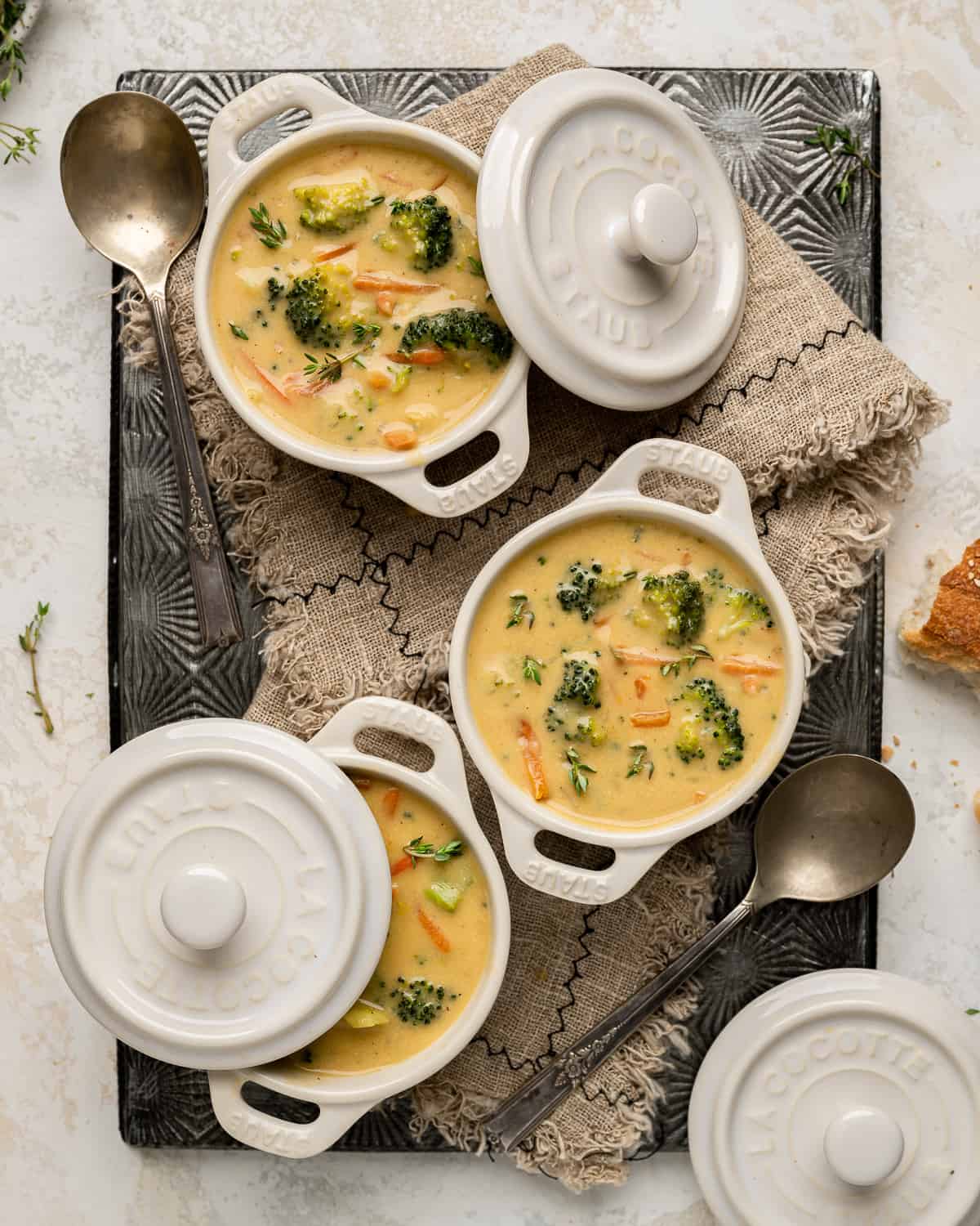 3 white ramekins filled with vegan broccoli cheddar soup