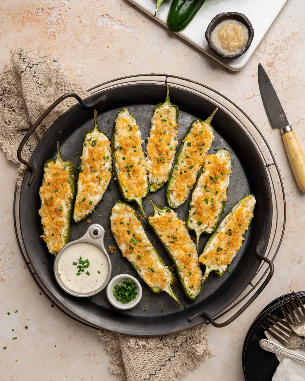 jalapeno poppers on a black serving tray.
