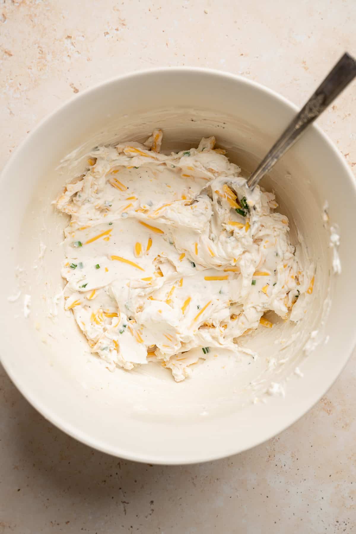 cream cheese mixture for filling jalapeno poppers in a bowl.