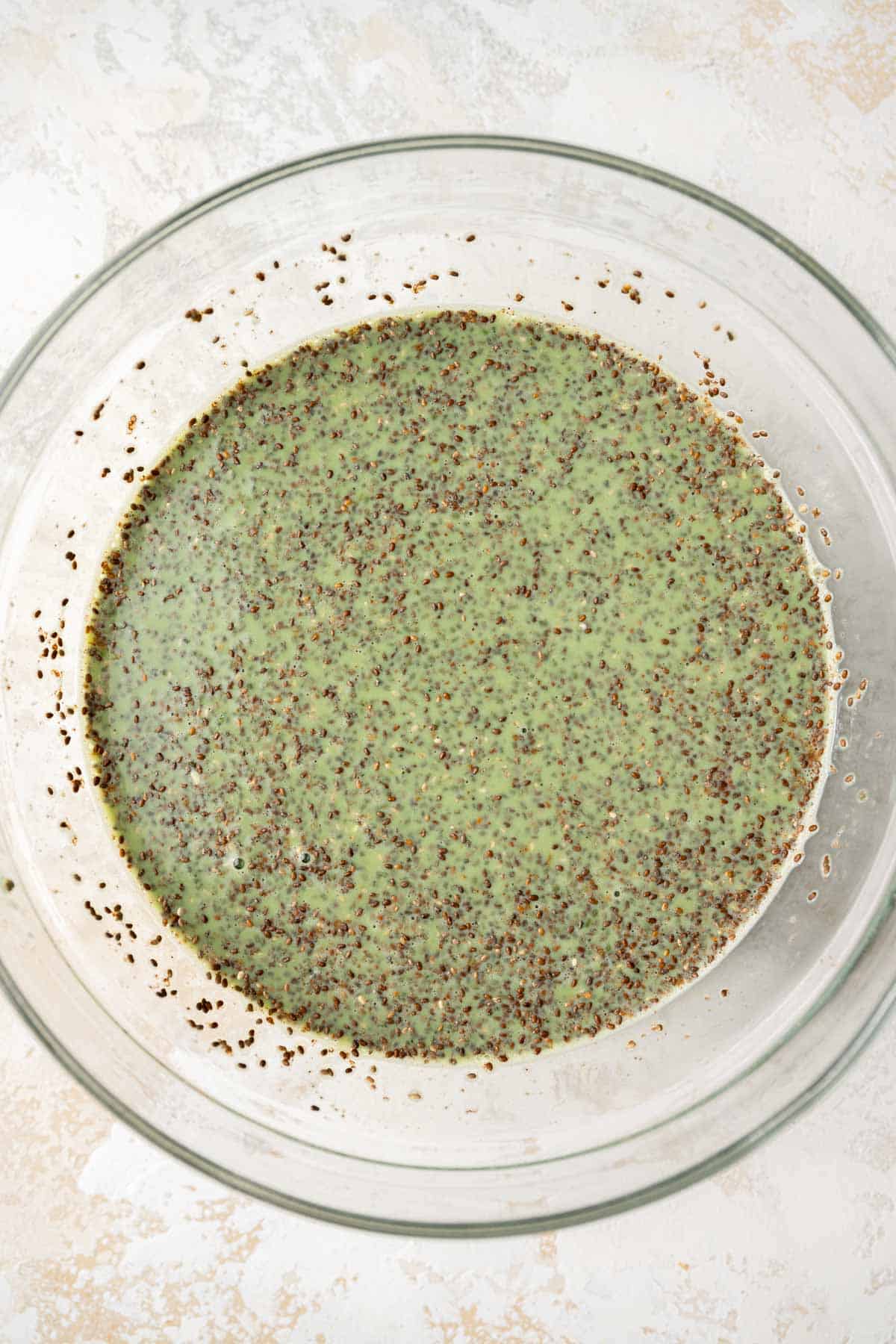 matcha chia seed pudding ingredients mixed in a bowl.