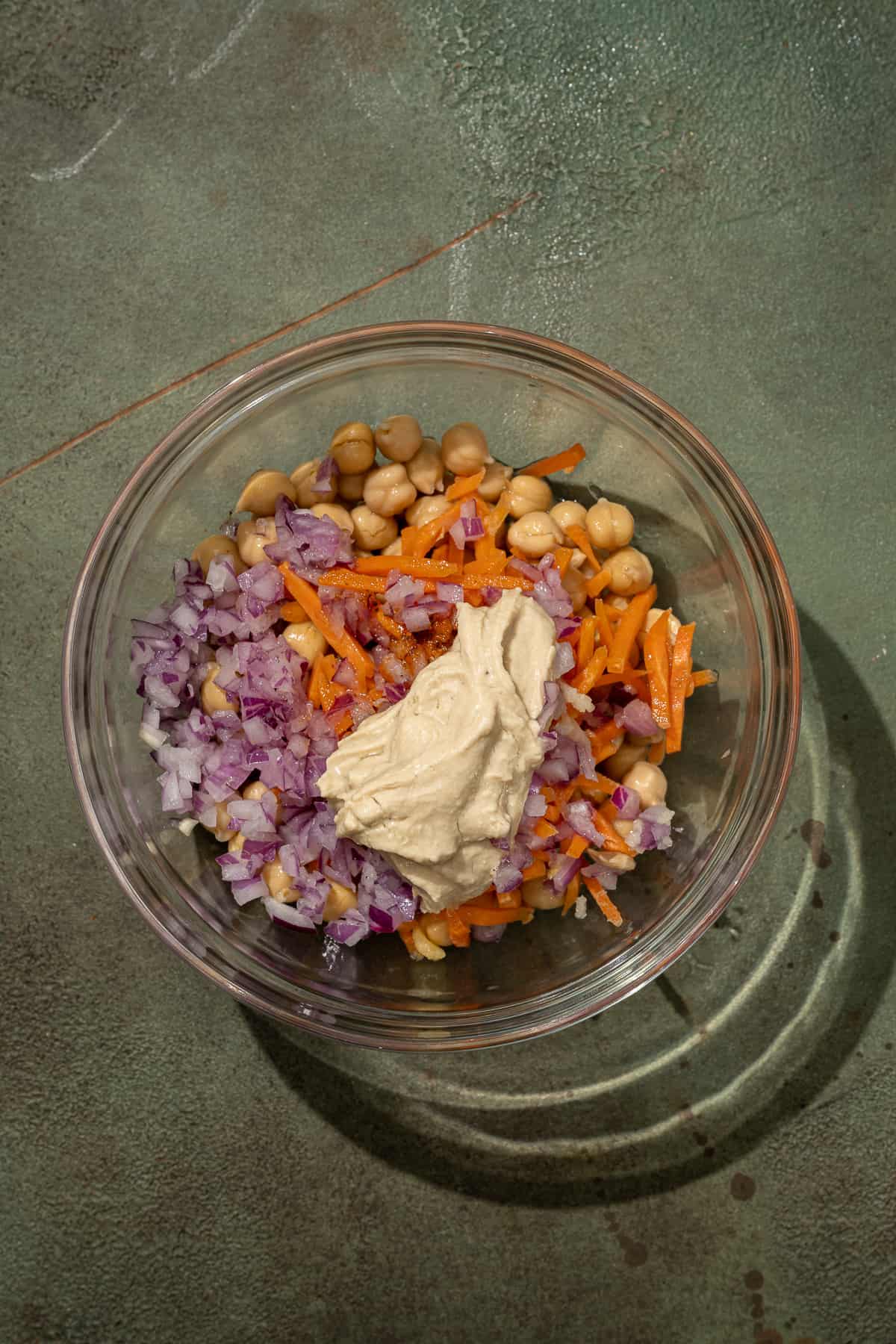 chickpea tuna salad ingredients in a glass bowl, unmixed.