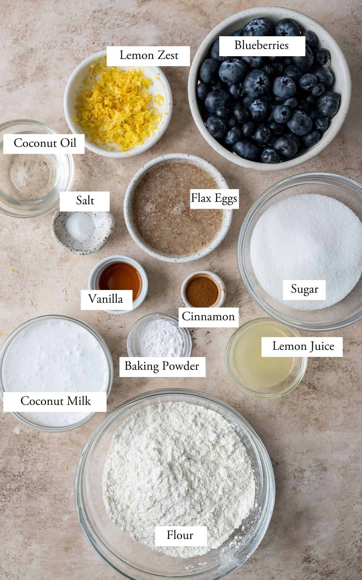 lemon blueberry muffin ingredients in bowls and labeled.
