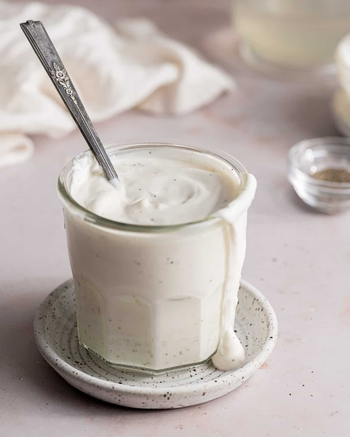 garlic aioli dripping down the side of a mason jar.