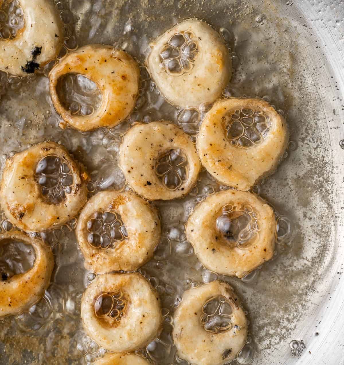calamari rings being deep fried in oil.