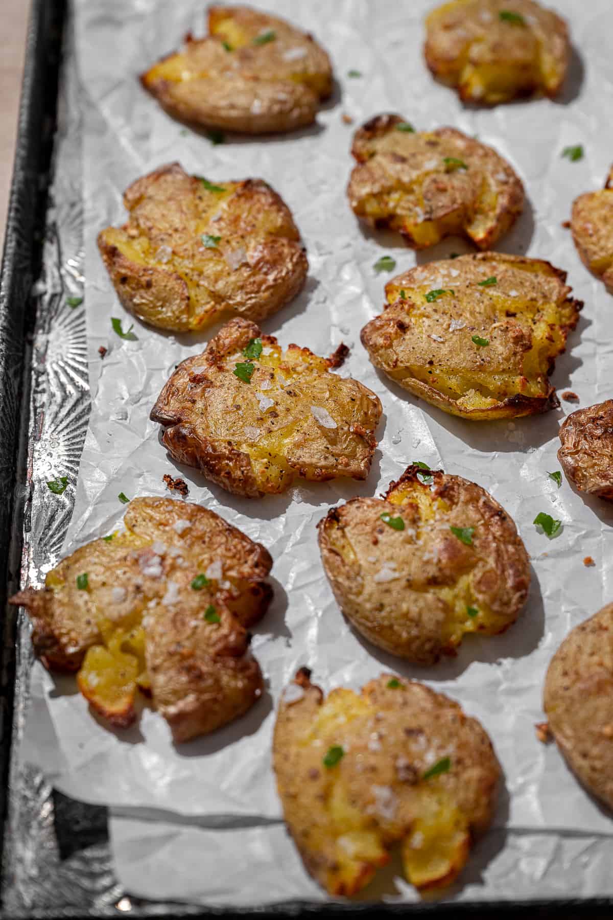 air fried smashed potatoes on parchment paper.