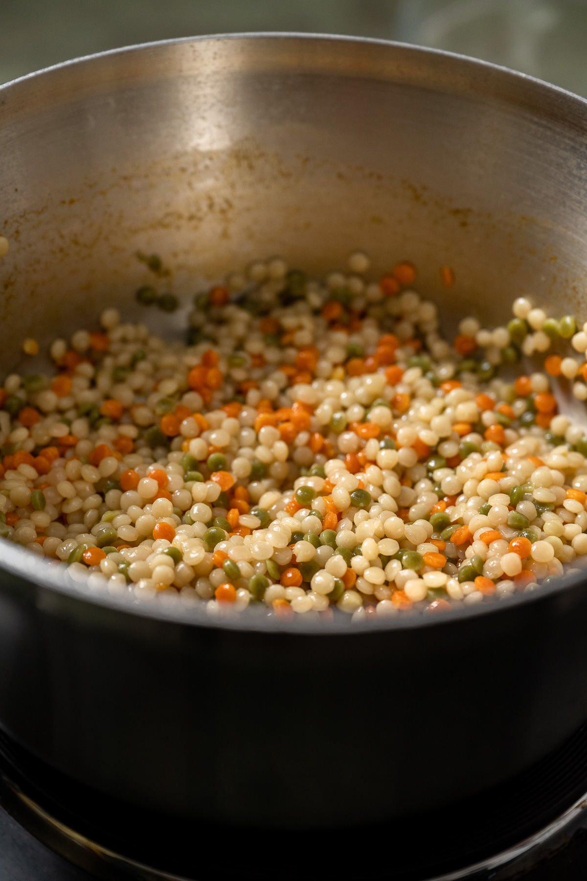 cooked tri-color pearl couscous in a pot.
