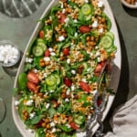 vegan couscous salad on a white serving platter.