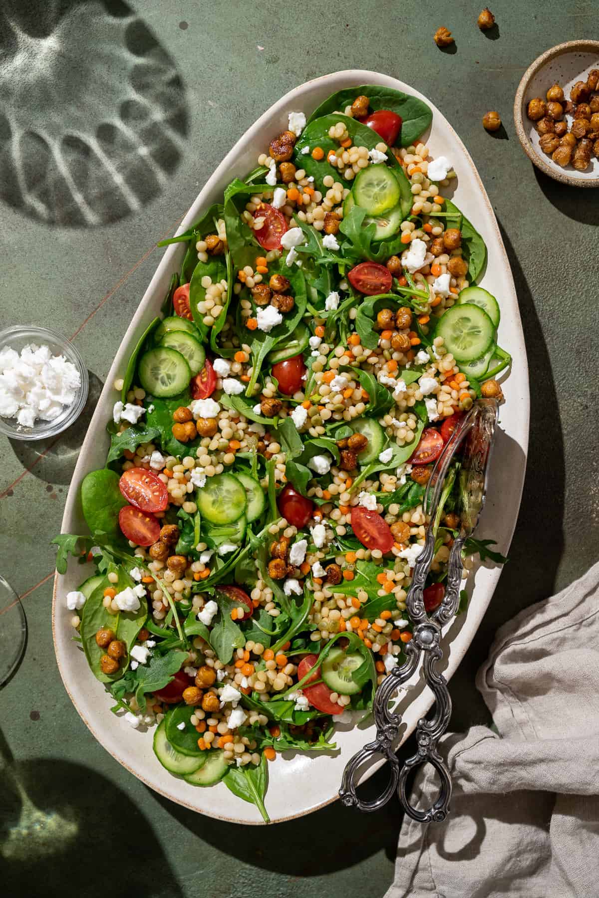 vegan couscous salad on a white serving platter.