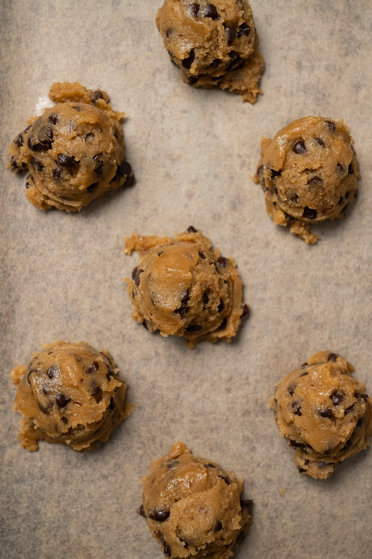 vegan peanut butter cookie dough balls on a baking sheet.