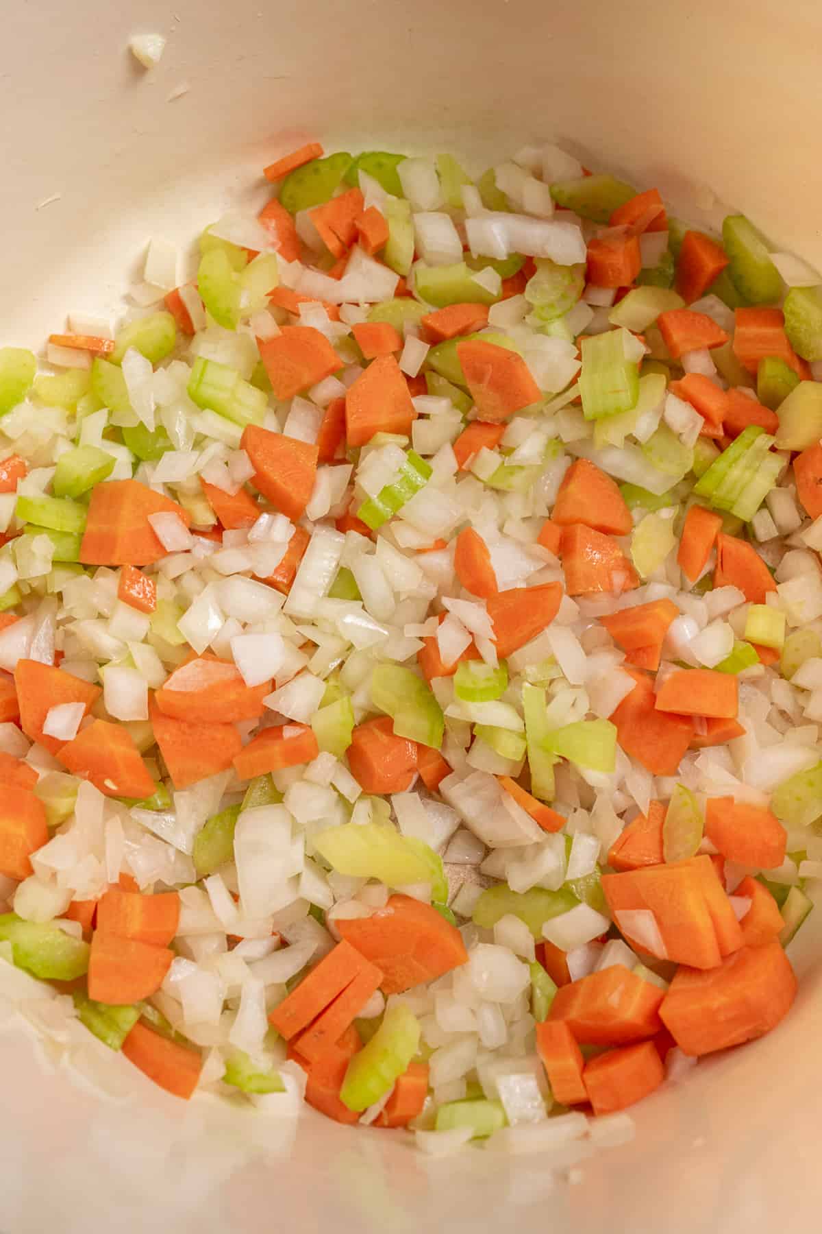 onion, garlic, celery and carrots being sauteed.