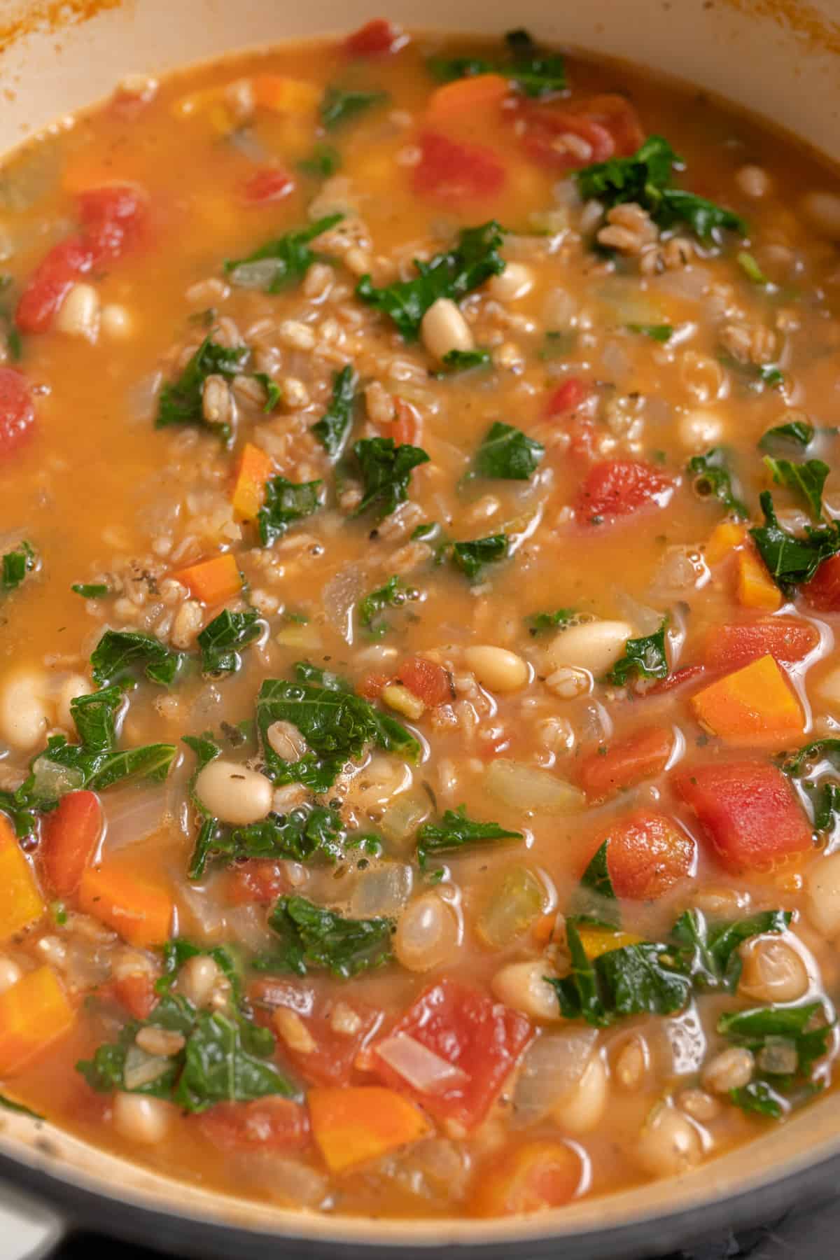 kale and parmesan added to pot of tuscan farro soup.
