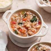 tuscan farro soup with white beans and vegetables in a bowl.
