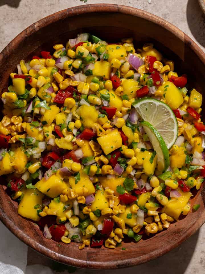close up of mango corn salsa in a serving bowl.