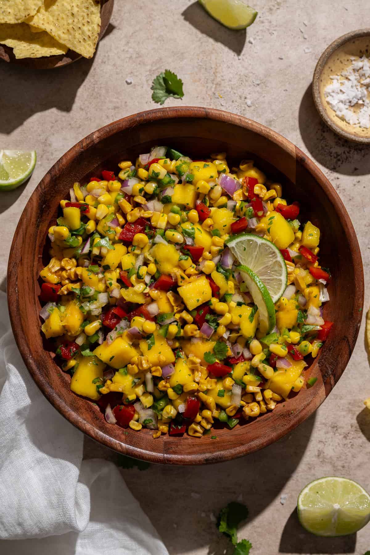 mango corn salsa in a wood serving bowl.